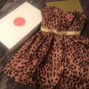 Honey’s strapless mini dress.   Cheetah print with full skirt. New with box